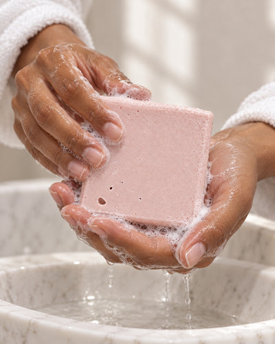 Geranium Sandalwood: Soap being lathered in wet hands